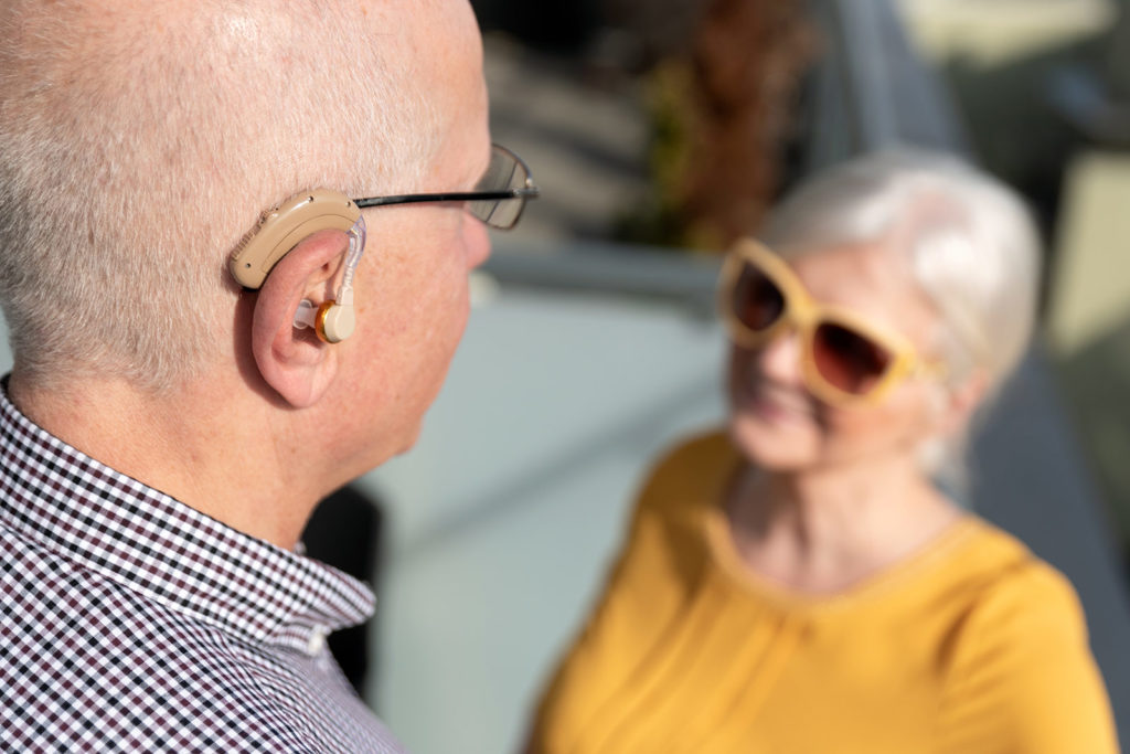 elderly couple with hearing aids